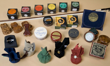 Several brands of violin rosin around a violin bow