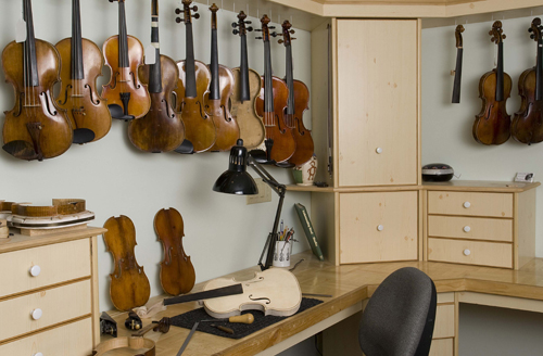 Sapp Violins' repair shop with many violins waiting for repair and tonal adjustments