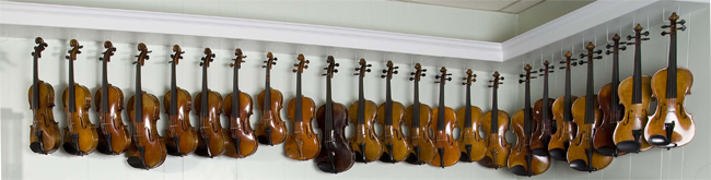 Violins and violas hanging on the wall at the Sapp Violin Shop in Montgomery